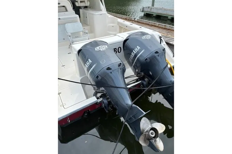 Jambo Yacht Photos Pics 2011 Pursuit OS 345 Offshore boat with twin Yamaha 350 engines docked at marina.