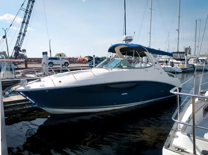 280 Sundancer Yacht Photos Pics 2016 Sea Ray 280 Sundancer boat docked at marina under clear sky.