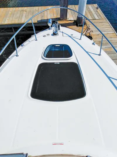 280 Sundancer Yacht Photos Pics 2016 Sea Ray 280 Sundancer boat deck with hatches, docked by wooden pier.