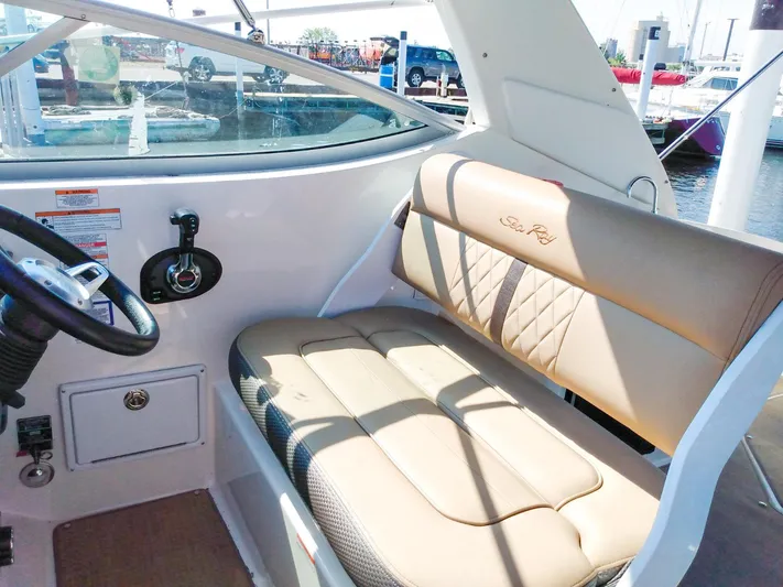 280 Sundancer Yacht Photos Pics 2016 Sea Ray 280 Sundancer interior with beige seating and steering wheel.