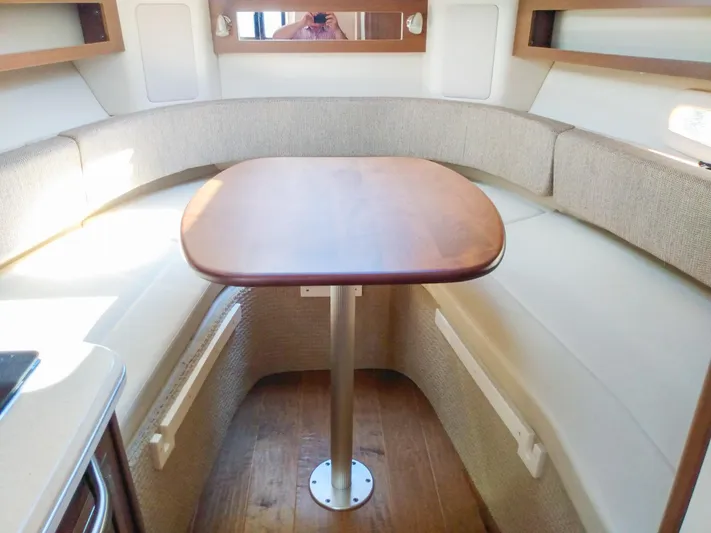 280 Sundancer Yacht Photos Pics Interior of 2016 Sea Ray 280 Sundancer with cozy seating and wooden table.