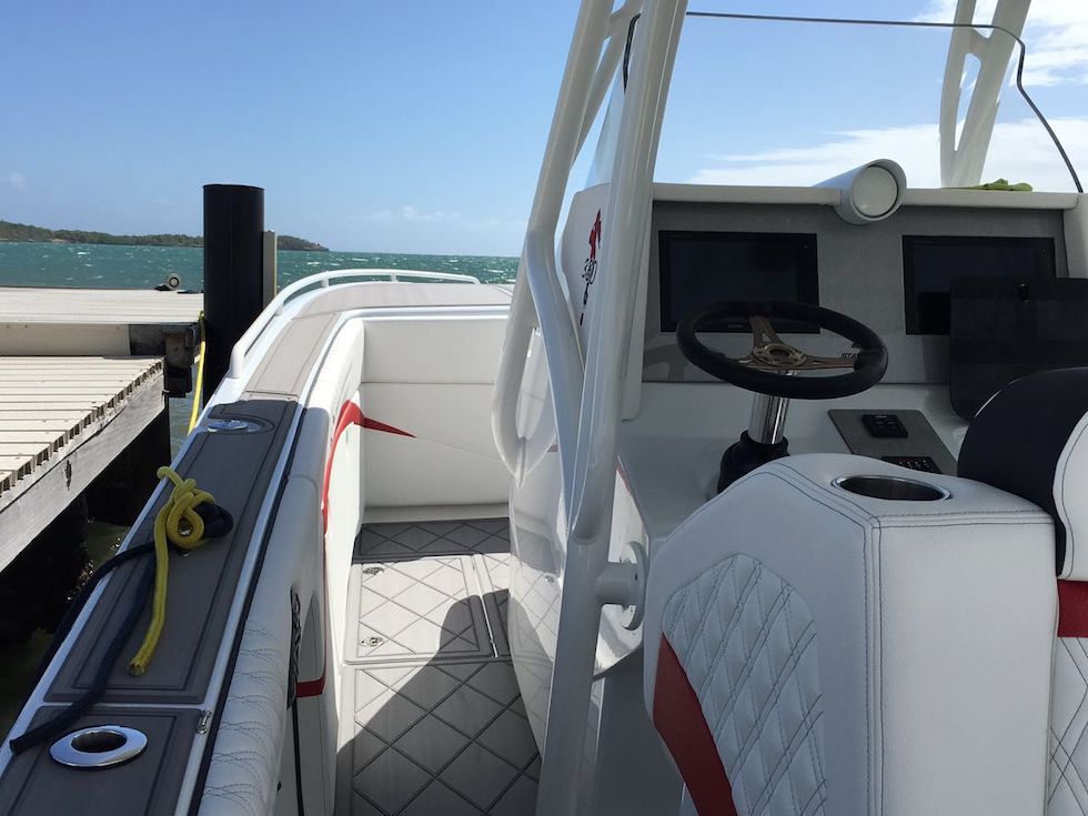 2017 Statement 380 SUV Cuddy boat interior with steering wheel and docked at marina.