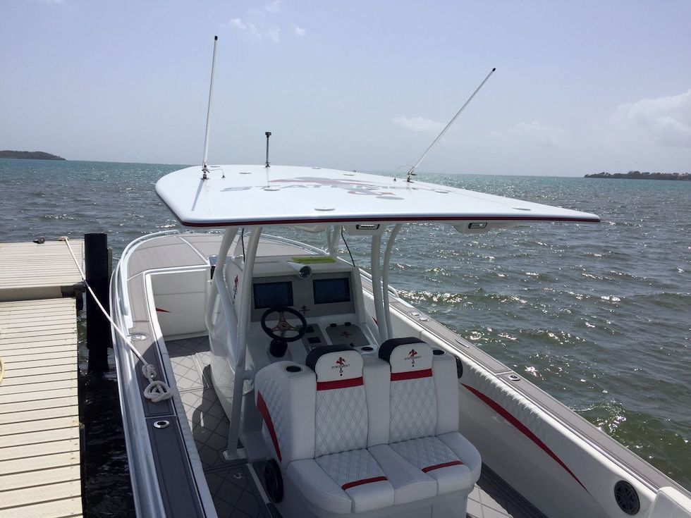 2017 Statement 380 SUV Cuddy boat docked by the sea, featuring a sleek design.