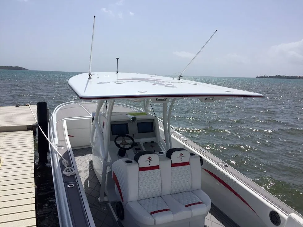 2017 Statement 380 SUV Cuddy boat docked by the sea, featuring a sleek design.