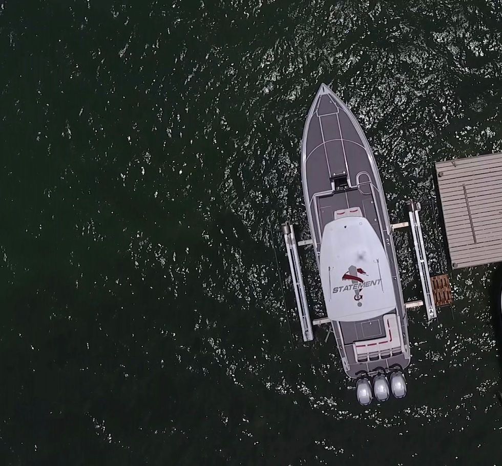 Overhead view of 2017 Statement 380 SUV Cuddy boat docked on water.