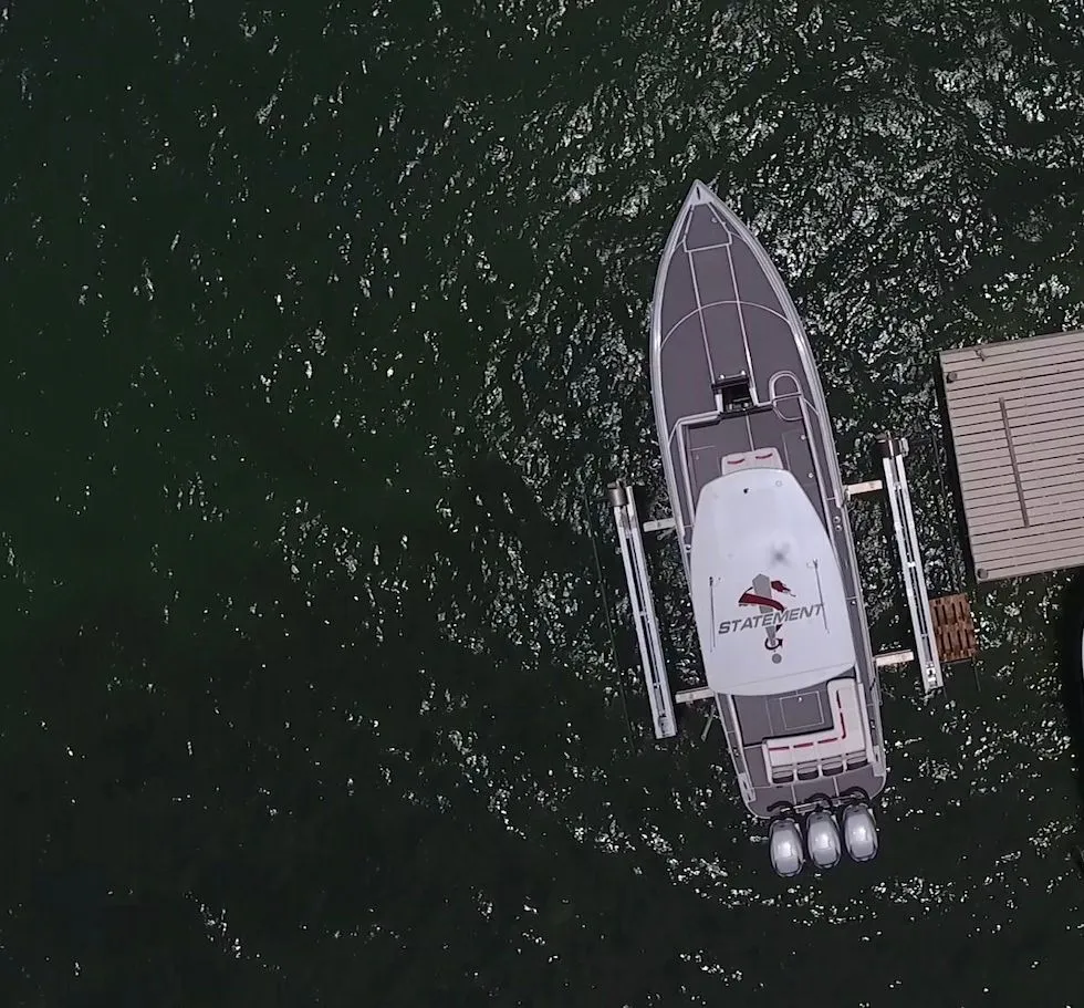 Overhead view of 2017 Statement 380 SUV Cuddy boat docked on water.