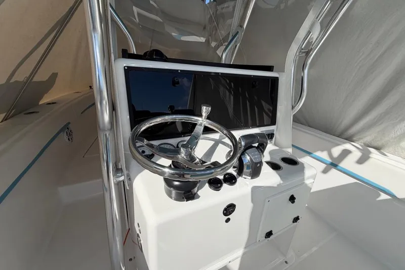  Yacht Photos Pics 2022 Bluewater 2850 CC boat console with steering wheel and controls.