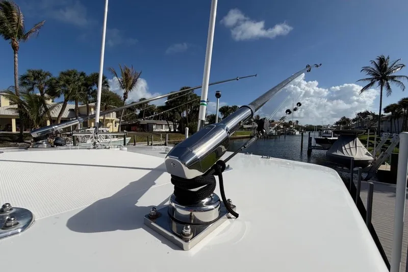  Yacht Photos Pics 2022 Bluewater 2850 CC boat with fishing outriggers, docked in a sunny marina.