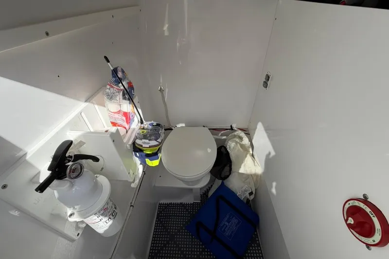  Yacht Photos Pics Interior of 2022 Bluewater 2850 CC boat with toilet, fire extinguisher, and safety equipment.