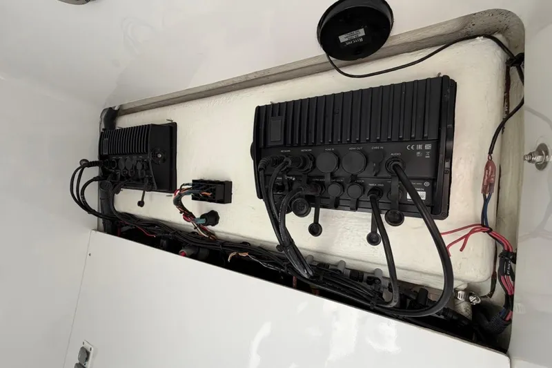  Yacht Photos Pics Electrical panel inside 2022 Bluewater 2850 CC boat, showcasing wiring and connections.