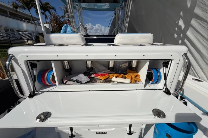  Yacht Photos Pics 2022 Bluewater 2850 CC boat storage compartment with fishing gear and accessories.