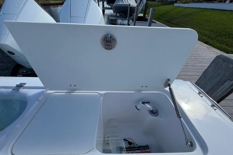  Yacht Photos Pics Open storage compartment on 2022 Bluewater 2850 CC boat, showcasing interior features.