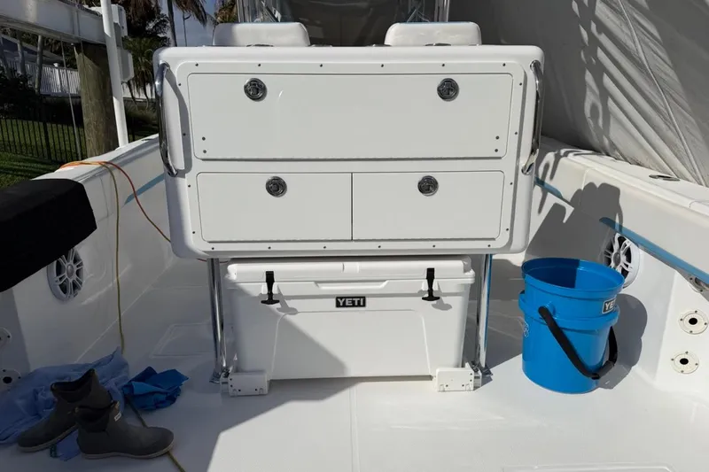  Yacht Photos Pics 2022 Bluewater 2850 CC boat interior with storage, Yeti cooler, and blue bucket.