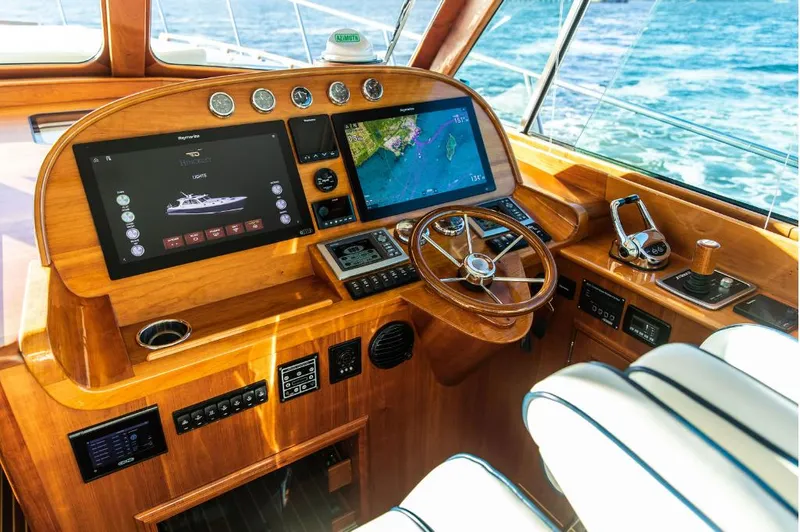 Cassidy Yacht Photos Pics Helm of 2013 Hinckley Talaria 48 MY yacht with navigation screens and wooden steering wheel.