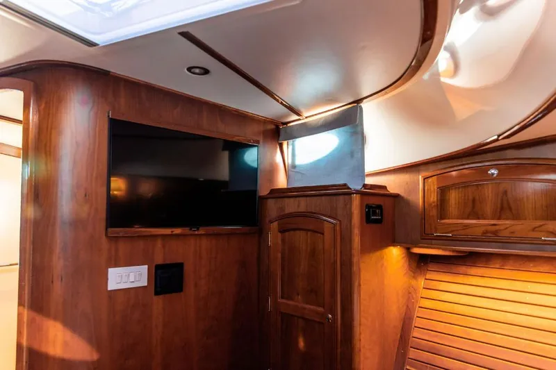 Cassidy Yacht Photos Pics Luxurious interior of 2013 Hinckley Talaria 48 MY yacht with wood paneling and TV.