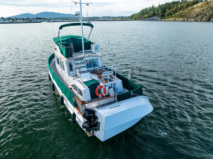 Sojourn Yacht Photos Pics 1990 Grand Banks 36 Classic yacht on calm water with scenic background.
