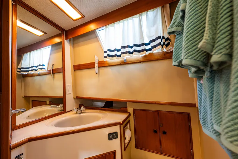 Sojourn Yacht Photos Pics Bathroom interior of 1990 Grand Banks 36 Classic yacht with sink and mirror.