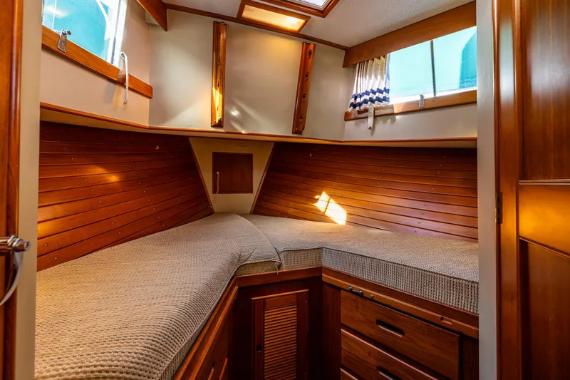 Sojourn Yacht Photos Pics Cozy cabin interior of 1990 Grand Banks 36 Classic with wooden finish and twin beds.