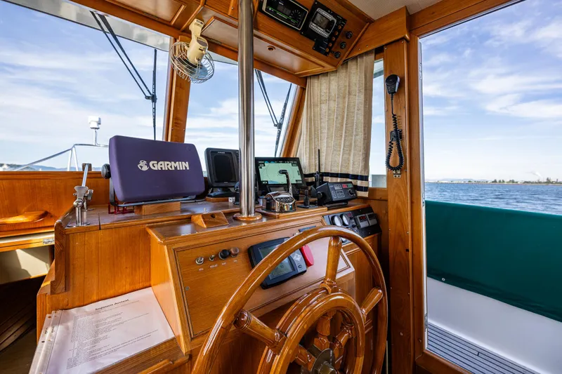 Sojourn Yacht Photos Pics Interior of 1990 Grand Banks 36 Classic boat with wooden helm and navigation equipment.
