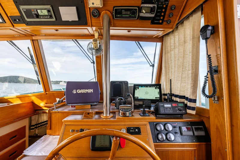 Sojourn Yacht Photos Pics Interior helm of 1990 Grand Banks 36 Classic with navigation equipment and wooden finish.