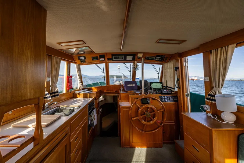 Sojourn Yacht Photos Pics Interior of 1990 Grand Banks 36 Classic yacht with wooden helm and navigation equipment.