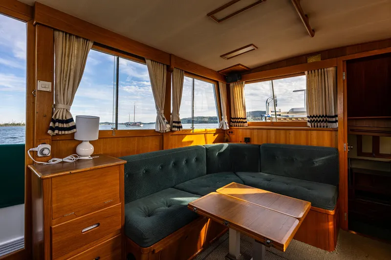 Sojourn Yacht Photos Pics Interior of 1990 Grand Banks 36 Classic yacht with cozy seating and wooden furnishings.
