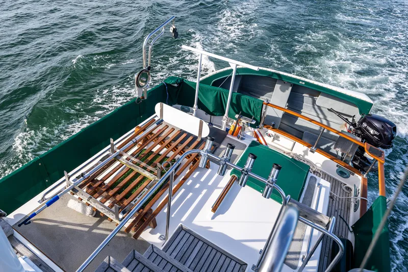 Sojourn Yacht Photos Pics 1990 Grand Banks 36 Classic yacht deck with green accents cruising on open water.