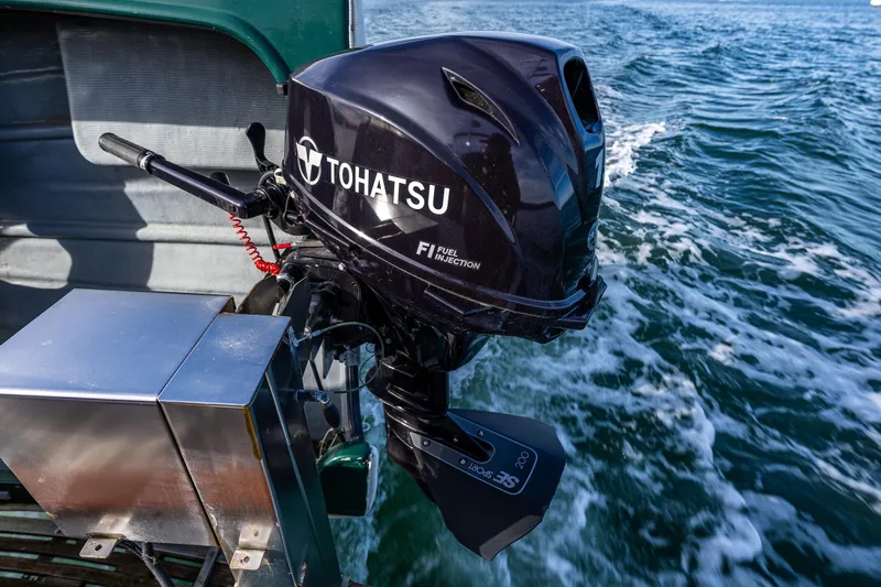 Sojourn Yacht Photos Pics Tohatsu outboard motor on 1990 Grand Banks 36 Classic, cruising on open water.