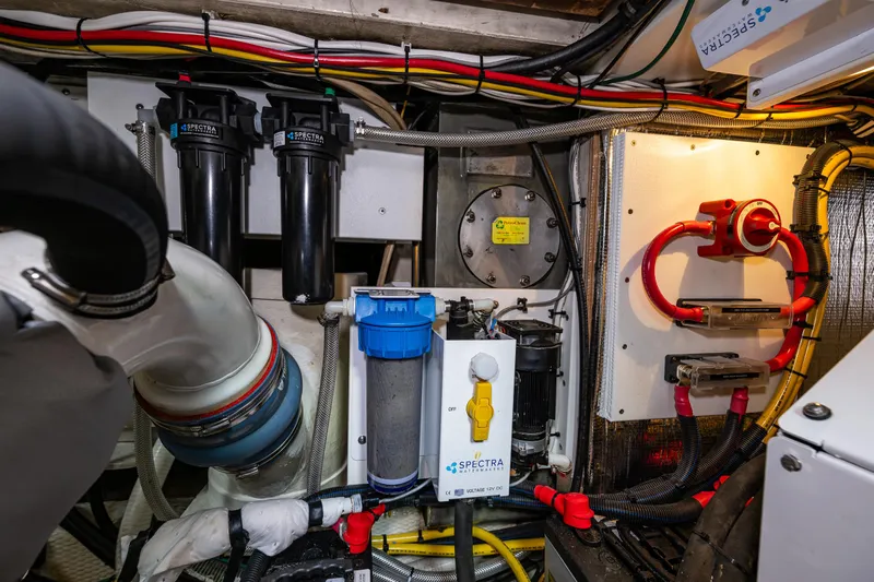 Sojourn Yacht Photos Pics Engine room of a 1990 Grand Banks 36 Classic, featuring various mechanical components and wiring.