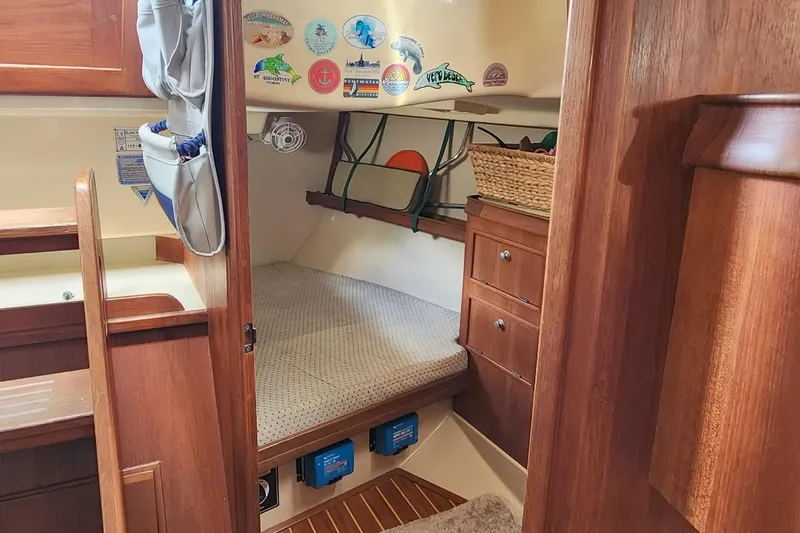 Ramble On Yacht Photos Pics Cozy cabin interior of 2000 Island Packet 380 sailboat with wooden furnishings and storage.