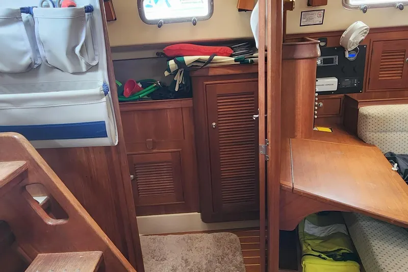 Ramble On Yacht Photos Pics Interior of 2000 Island Packet 380 sailboat with wooden cabinetry and seating area.