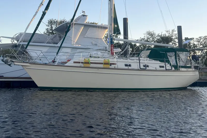 Ramble On Yacht Photos Pics Sailboat Island Packet 380, 2000 model, docked in calm waters at sunset.