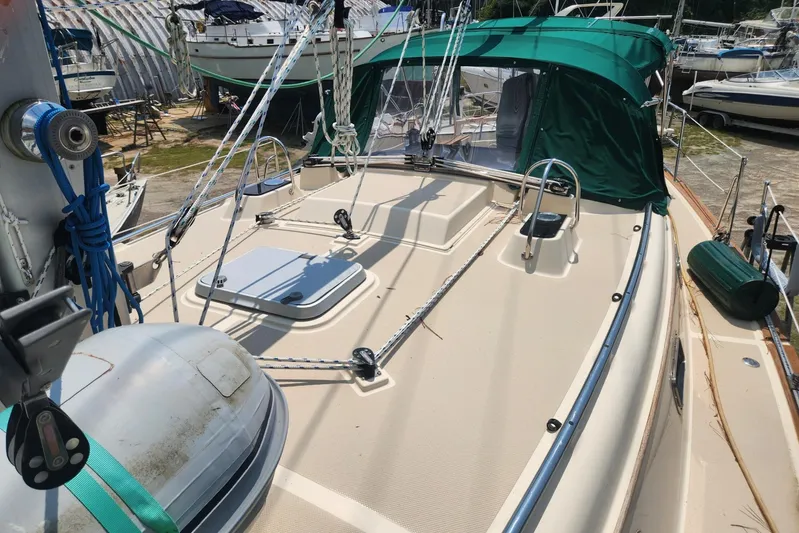 Ramble On Yacht Photos Pics Island Packet 380 sailboat deck, 2000 model, with green canopy and rigging.