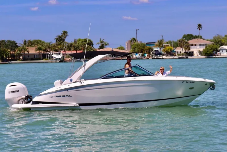  Yacht Photos Pics 2018 Regal 29 OBX boat cruising on a sunny day with passengers waving.