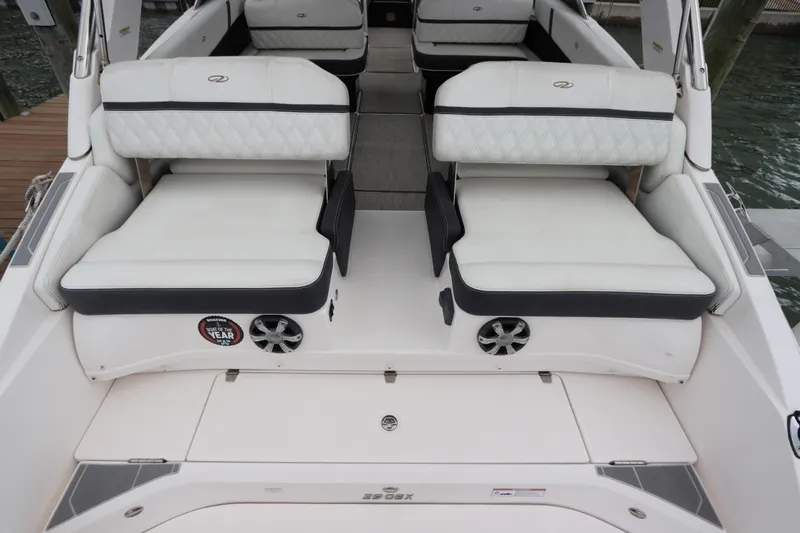  Yacht Photos Pics 2018 Regal 29 OBX boat interior with white cushioned seating and speaker system.