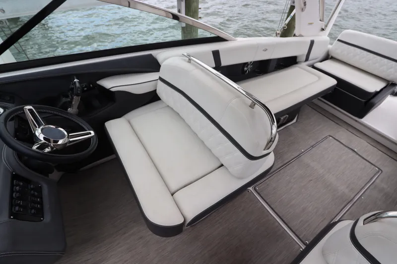  Yacht Photos Pics Luxurious interior of 2018 Regal 29 OBX boat with plush seating and sleek steering wheel.