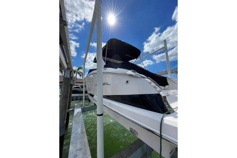  Yacht Photos Pics 2018 Regal 29 OBX boat docked under sunny blue sky.