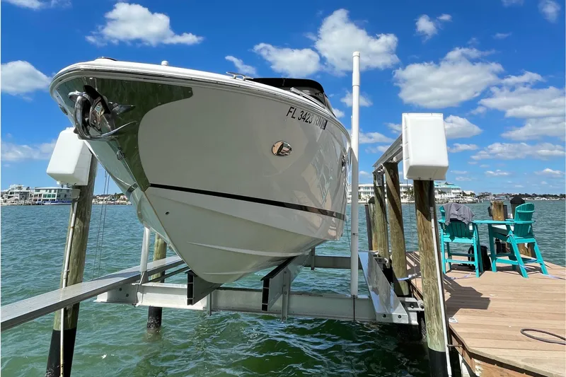  Yacht Photos Pics 2018 Regal 29 OBX boat on lift at dock, sunny day, blue sky.