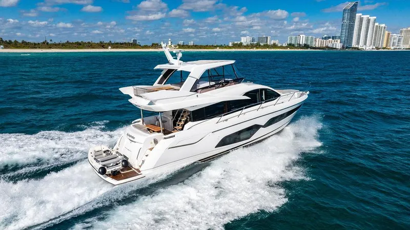 My Inspiration Yacht Photos Pics 2019 Sunseeker Manhattan 66 yacht cruising in blue ocean near city skyline.