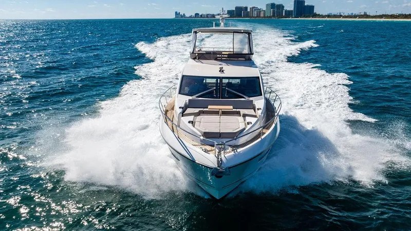 My Inspiration Yacht Photos Pics 2019 Sunseeker Manhattan 66 yacht cruising on open water, city skyline in background.