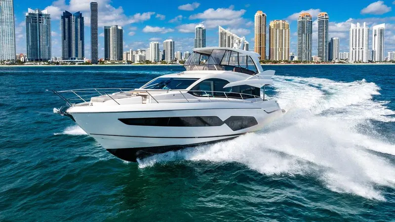 My Inspiration Yacht Photos Pics 2019 Sunseeker Manhattan 66 yacht cruising near city skyline on a sunny day.