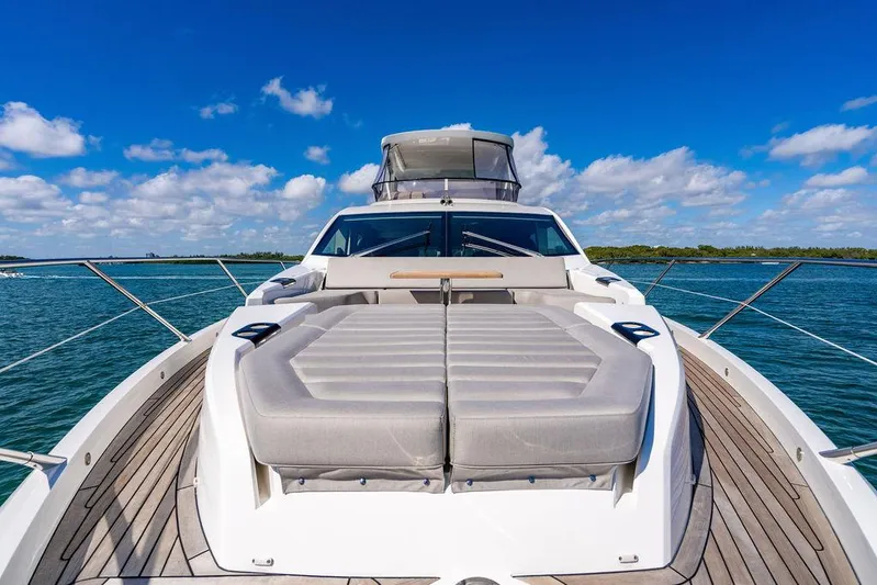 My Inspiration Yacht Photos Pics 2019 Sunseeker Manhattan 66 yacht, spacious deck, luxurious seating, clear blue sky, serene water.
