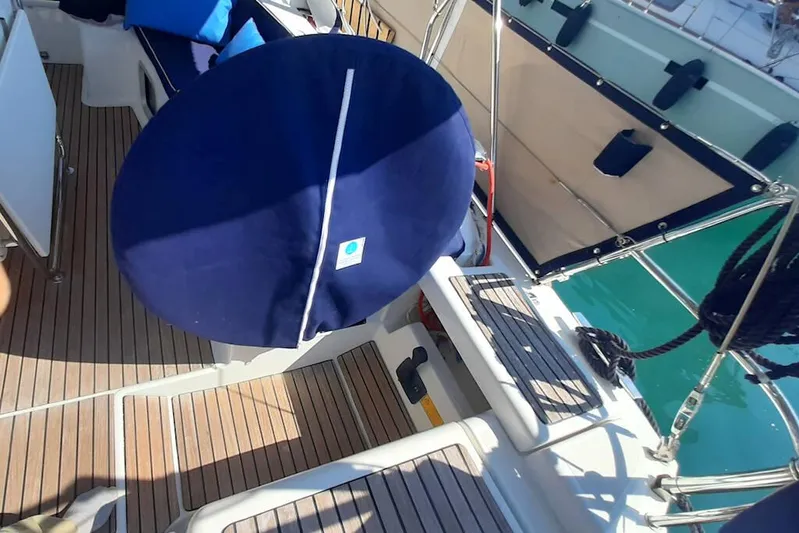  Yacht Photos Pics 2013 Jeanneau Sun Odyssey 439 performance yacht deck with blue cover and wooden flooring.