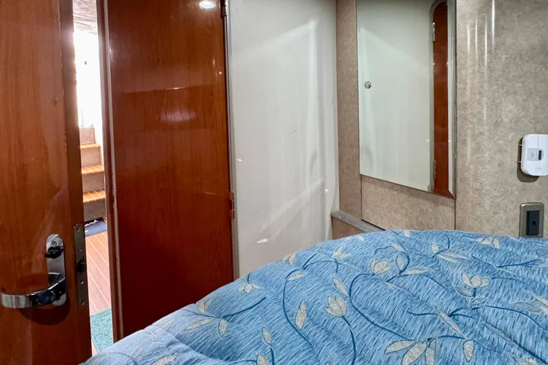 40 Formula Pc Yacht Photos Pics Interior of 2006 Formula 40 PC yacht cabin with wooden door and blue floral bedding.