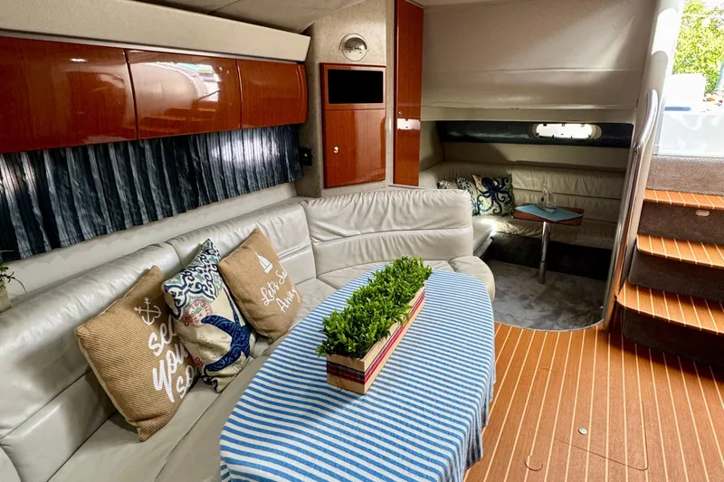 40 Formula Pc Yacht Photos Pics 2006 Formula 40 PC yacht interior with cozy seating, striped tablecloth, and decorative pillows.