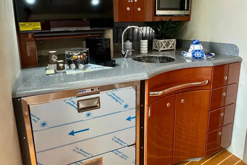 40 Formula Pc Yacht Photos Pics 2006 Formula 40 PC yacht kitchen with modern appliances and wooden cabinetry.