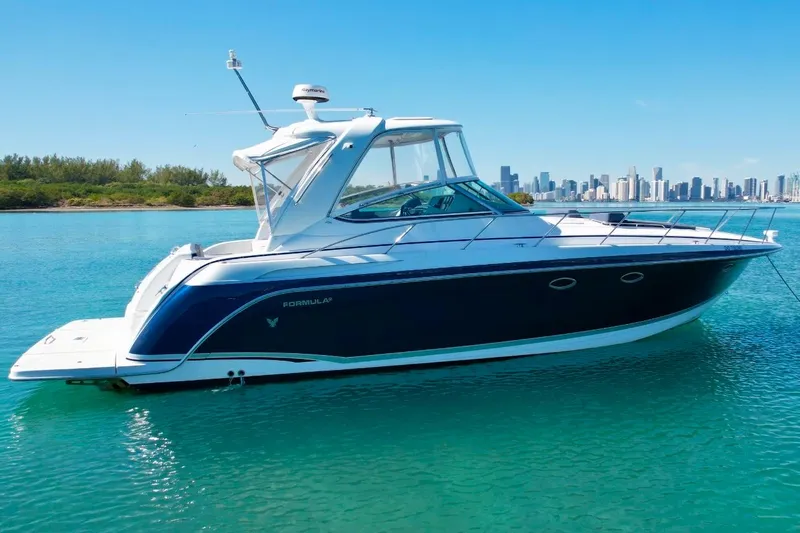 40 Formula Pc Yacht Photos Pics 2006 Formula 40 PC yacht on clear blue water with city skyline in background.