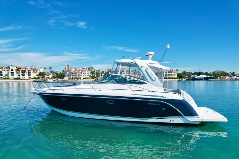 40 Formula Pc Yacht Photos Pics 2006 Formula 40 PC yacht on clear blue water with scenic coastal backdrop.