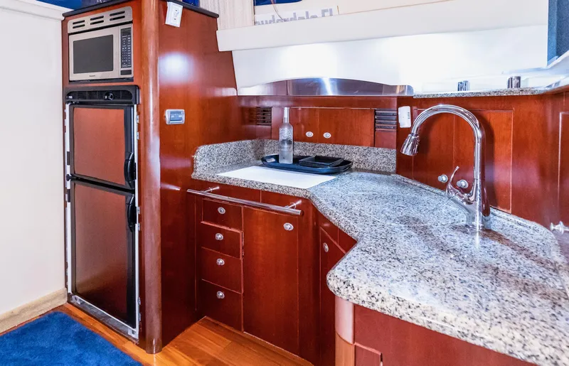 One Love Yacht Photos Pics Luxurious kitchen area in a 2006 Sea Ray 44 Sedan Bridge yacht with granite countertops.