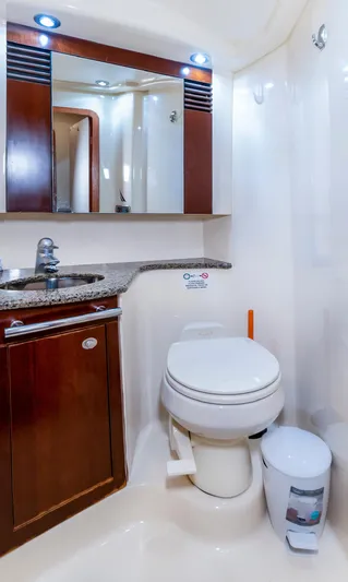 One Love Yacht Photos Pics Luxurious bathroom in 2006 Sea Ray 44 Sedan Bridge yacht with modern fixtures and wood accents.